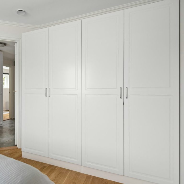 Modern white wardrobe with multiple doors in a minimalist interior setting.