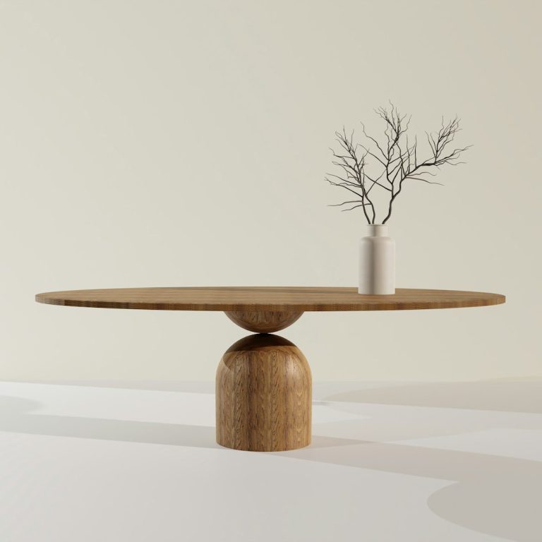 Wooden table with a round top and a cylindrical base, featuring a vase with a bare branch.